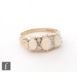 A 9ct hallmarked opal and diamond seven stone ring, three opals spaced by two pairs of diamonds,