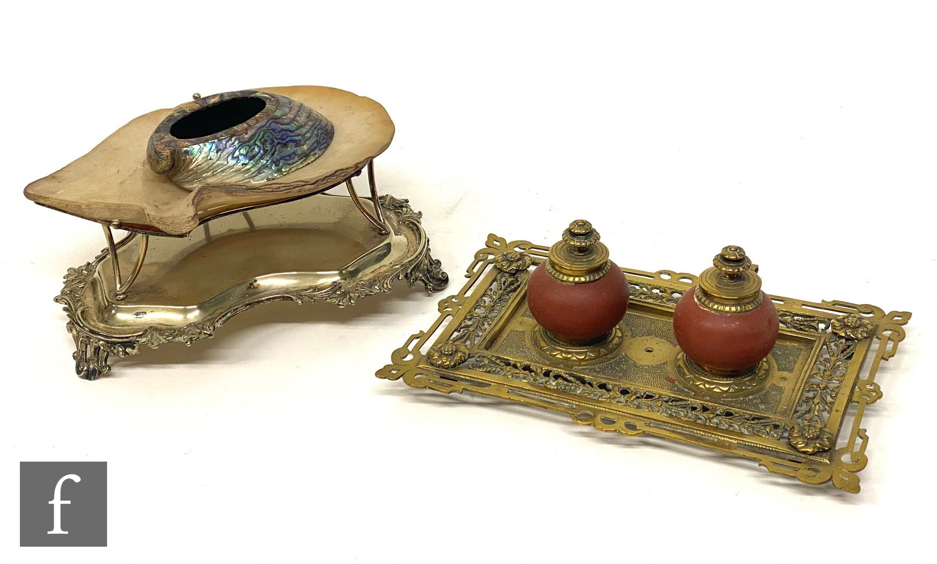 A Victorian oyster shell sweet meat dish on plated stand and a brass ink stand fitted with two