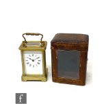 A late 19th century French brass carriage clock in leather carrying case, height 11.5cm.
