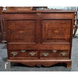 A small early 19th Century oak mule chest, the moulded edge top over an inlaid paterae front, on