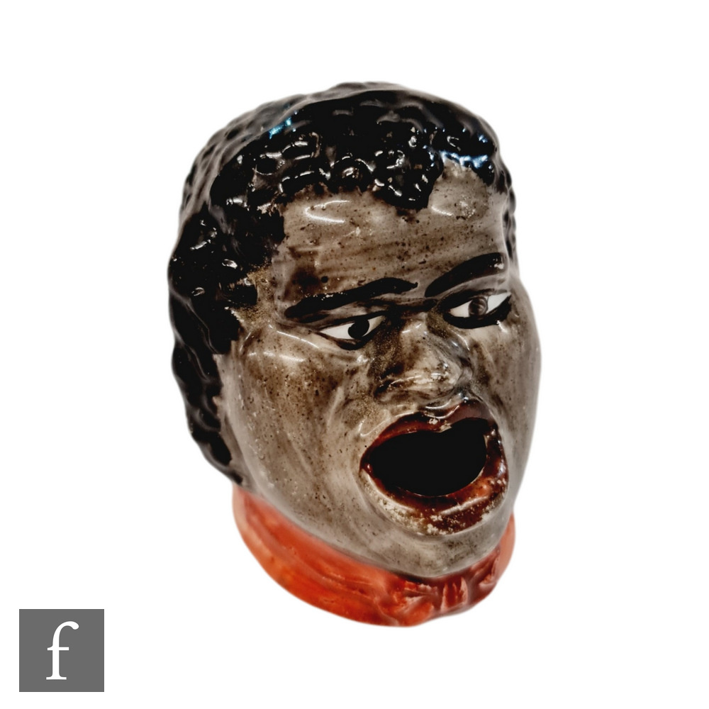 A 19th Century Staffordshire dip pen inkwell modelled as the head of a black boy with open mouth and