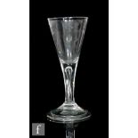 An 18th Century wine glass circa 1740, the drawn trumpet bowl above a teared stem, raised to a