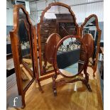 A Queen Anne style triple fold walnut dressing table mirror on shaped legs, width 81cm, and a