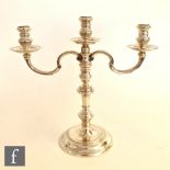 A hallmarked silver small three light candelabrum, circular stepped base below knopped stem and