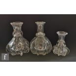 A trio of 19th Century Newcastle type carafes each with a fluted body and flared collar neck,