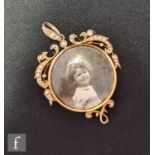 An early 20th Century 15ct circular open locket detail with part seed pearl set border, length 5.