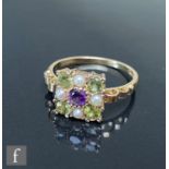 A 9ct hallmarked Edwardian style amethyst, peridot and seed pearl ring, central amethyst within
