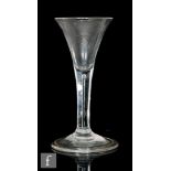 An 18th Century wine glass circa 1740, the trumpet bowl above a teared stem, raised to a folded