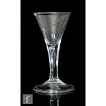 An 18th Century wine glass circa 1740, the trumpet bowl above a teared stem, raised to a folded