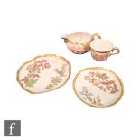 A late 19th Century Royal Worcester blush ivory trio in the Aesthetic taste decorated with flowers