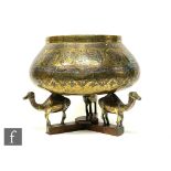 An early 20th century Middle Eastern brass jardiniere decorated with silver and copper inlay