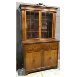 A late 19th to early 20th Century mahogany secretaire bookcase enclosed by a pair of bar glazed