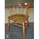 A 20th Century elm and beech smoker's bow style elbow chair.