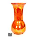 Ruskin Pottery - A vase of globe and shaft form decorated in an all over orange lustre, impressed