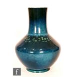 Ruskin Pottery - A souffle glazed vase of angular form with a cylinder neck decorated in a mottled