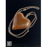 Copenhagen - A Danish ceramic heart shaped pendant in a brown lustre, length 7cm, suspended from a