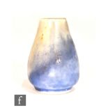 Ruskin Pottery - A miniature vase of swollen form decorated in a yellow to blue crystalline glaze,
