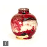 Ruskin Pottery - A miniature high fired vase of globular form with a cylinder neck, the whole