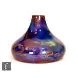 Bernard Moore - A small early 20th Century squat vase decorated in an iridescent flambe glaze with