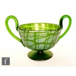 In the manner of Loetz - An early 20th Century glass twin handled pedestal cup in green with a