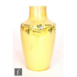 Ruskin Pottery - A small vase decorated in an all over yellow lustre with a painted garland to the