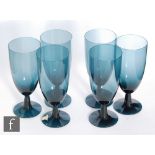 A set of six post war Swedish dark indigo wine glasses by Gullaskruf, each with an elongated ovoid