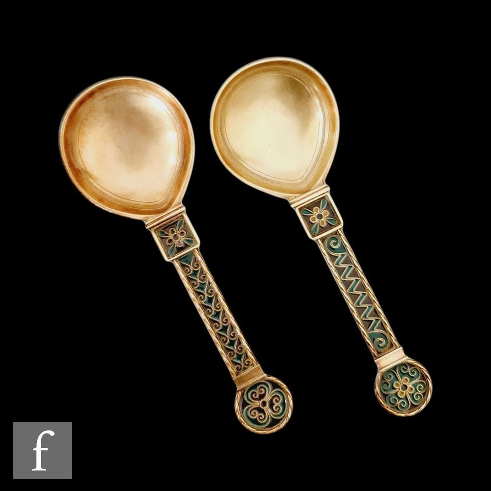 Two silver gilt and plique a jour spoons, the wide gilt bowls rising to plique a jour decorated