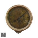 A 20th Century Smiths car dashboard clock, Arabic numerals to a brass dial, case diameter 9.5cm.