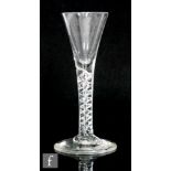 An 18th Century drinking glass, circa 1750, the drawn trumpet bowl above a single series air twist