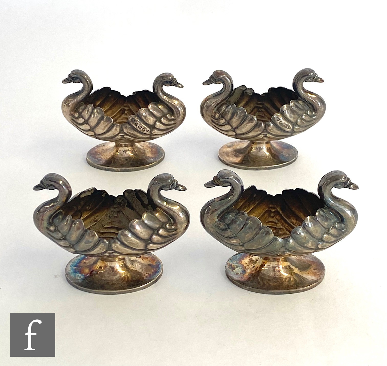 A set of four hallmarked silver pedestal open salts each modelled as two swans, total weight 4oz,