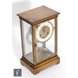 A 19th century French gilt brass mantle clock with suspended circular Arabic dial and mercury