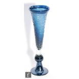 A later 20th Century glass vase of trumpet form, the blue core cased in clear and acid cut with an