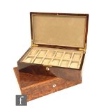 Two modern rectangular lacquered burr walnut watch boxes each with twelve compartments, length 37cm,