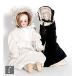 A Victorian wooden peg doll, with painted face with pronounced nose and jointed body, dressed in a