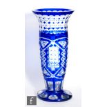 An early 20th Century continental glass vase of footed tapering form, cased in blue over clear and