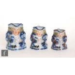 A set of three late 19th Century graduated blue Gaudy Welsh Toby jugs each sat holding a jug of