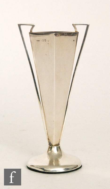 A hallmarked silver bud vase of footed form with flared diamond form body and applied twin angular
