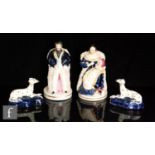 A pair of 19th Century Staffordshire figures modelled as Queen Victoria with a baby on her knee, and