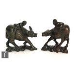 A pair of 20th Century Chinese carved hardwood figures, modelled as water buffalo, inlaid with