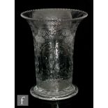 An early 20th Century Webb Corbett clear crystal vase of footed cylindrical form with a flared