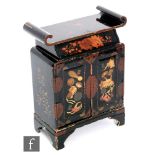An early 20th century Japanese lacquered trinket cabinet fitted with seven drawers enclosed by a