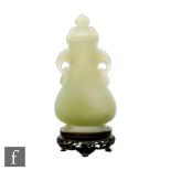 A Chinese 20th Century green hardstone vase of pear form mounted with two ring drop handles below