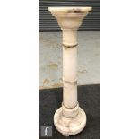A 20th century white alabaster pedestal of Doric form with octagonal top and gilt collar mounts,