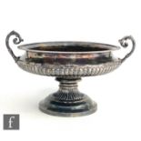 A hallmarked silver twin handled pedestal bowl, circular stepped foot below part fluted body,