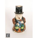 A C.H Brannam character jug modelled as Winston Churchill sat holding a walking cane and smoking a