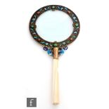 A 19th century Chinese magnifying glass, the lens bordered with a band of enamel flowers and