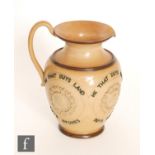 An early 20th Century Doulton Lambeth stoneware motto jug decorated to the body with the motto 'He