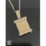 A contemporary 9ct white gold diamond floodlight pendant comprising forty three individually set