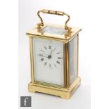 An early 20th century French brass carriage clock, white enamelled dial, on bracket plinth, height