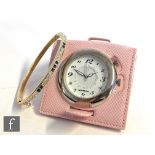 A Montblanc stainless steel quartz travel alarm clock, model number 7056, within a pink leather